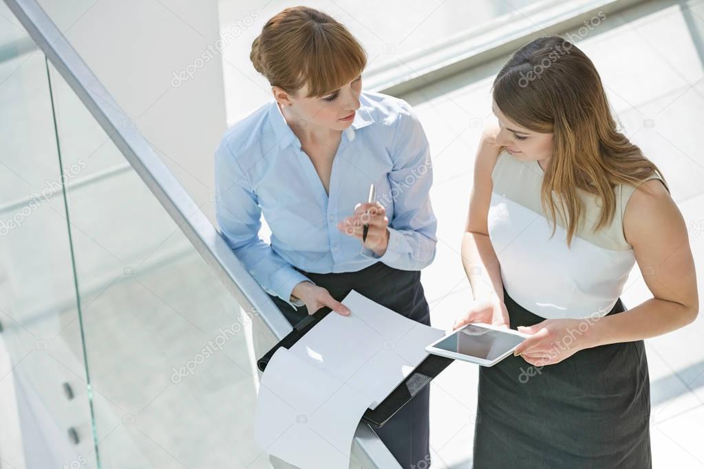 Businesswomen discussing over tablet PC