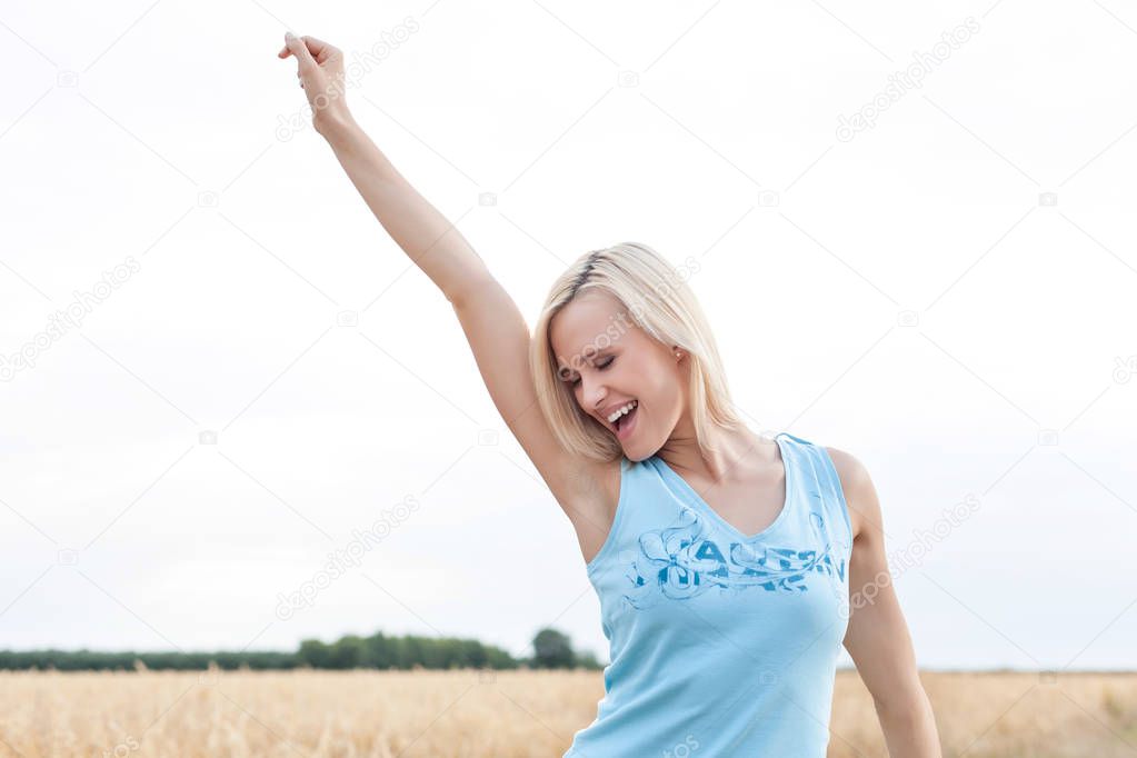 young woman with arm raised