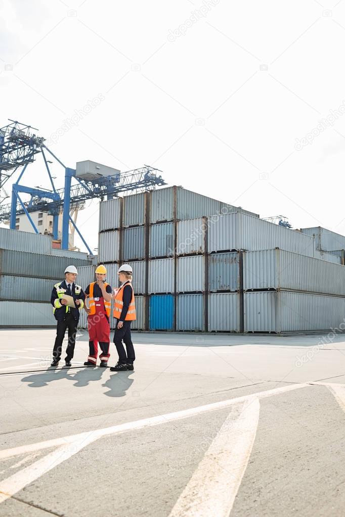 Workers talking in shipping yard