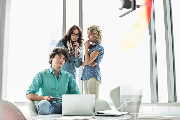 Confident businessman sitting at table — Stock Photo, Image