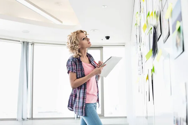 Creative businesswoman looking at papers — Stock Photo, Image