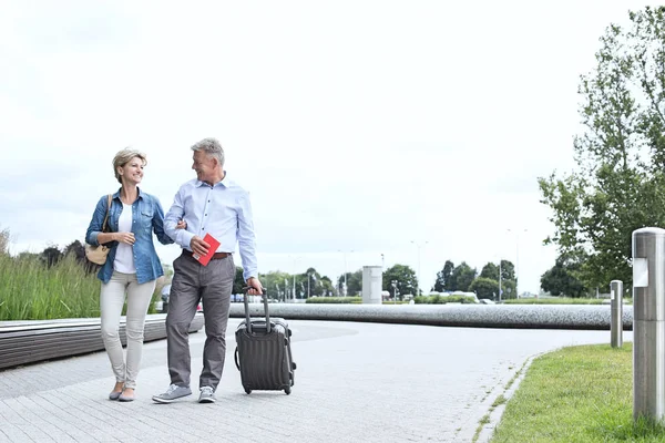 Middle-aged couple with luggage