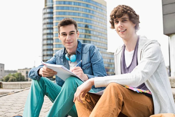 Male students studying on steps — Stock Photo, Image