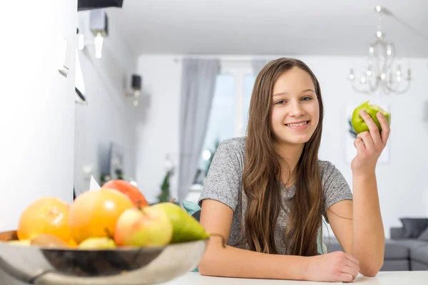 Smiling girl holding apple — Stock Photo, Image