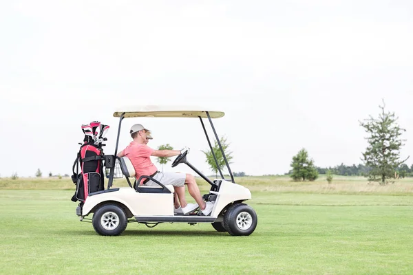 Casal sentado no carrinho de golfe — Fotografia de Stock