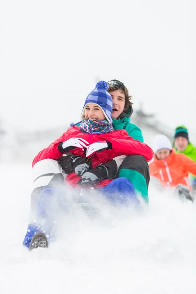 Excited young friends sledding — Stock Photo, Image
