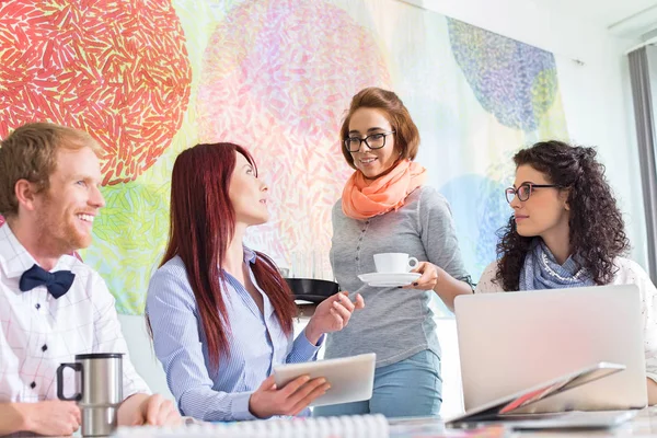 Geschäftsfrau schenkt Kollegin Kaffee — Stockfoto