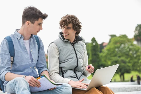 Giovani amici universitari maschi con laptop — Foto Stock