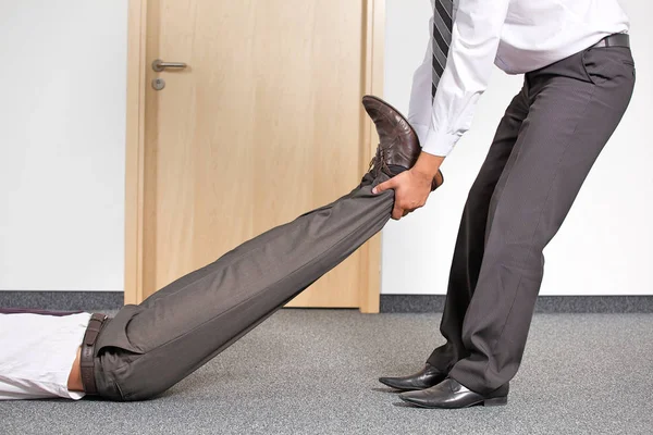 Businessmen pulling colleague — Stock Photo, Image