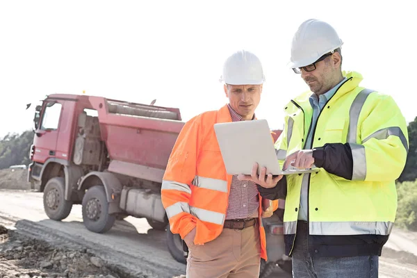 Engineers using laptop at construction site — Stock Photo, Image