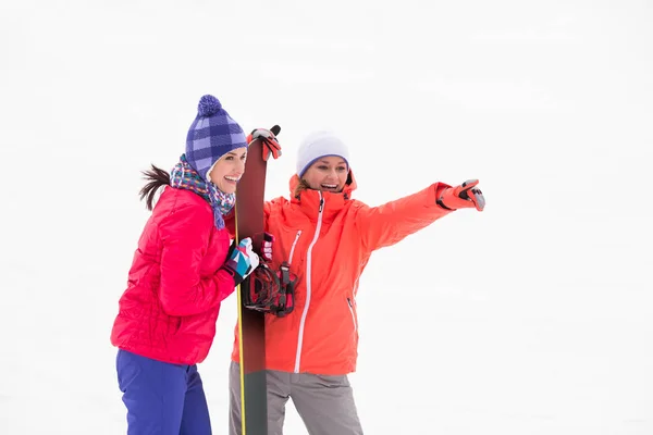 Excited female friends with snowboard — Stock Photo, Image