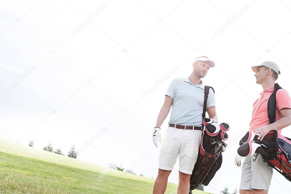 Male friends conversing at golf course