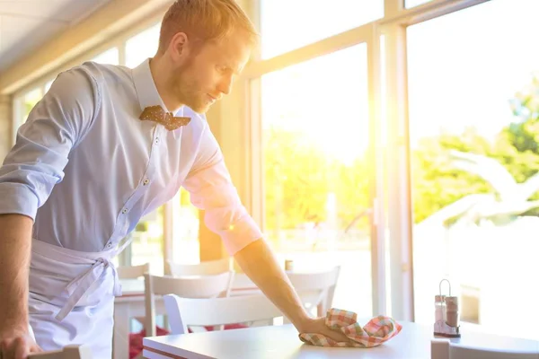 Attractive Waiter Wiping Table — Stock Photo, Image