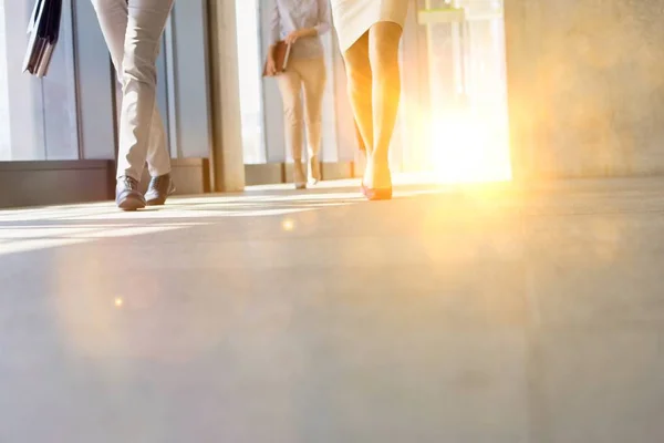 Business People Walking While Talking Office Hall Yellow Lens Flare — Stock Photo, Image