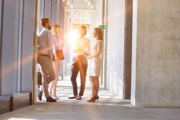 Business People Walking While Talking Office Hall Yellow Lens Flare — kuvapankkivalokuva