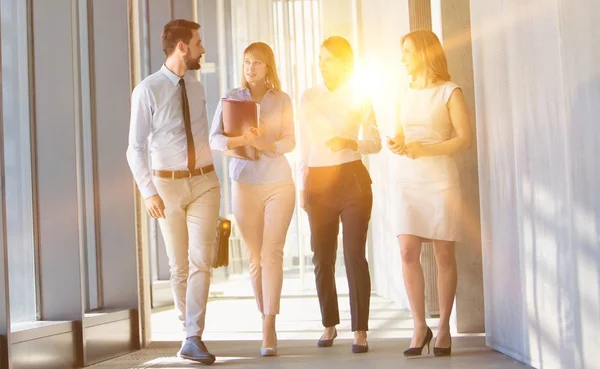 Business People Walking While Talking Office Hall Yellow Lens Flare — Stock Photo, Image