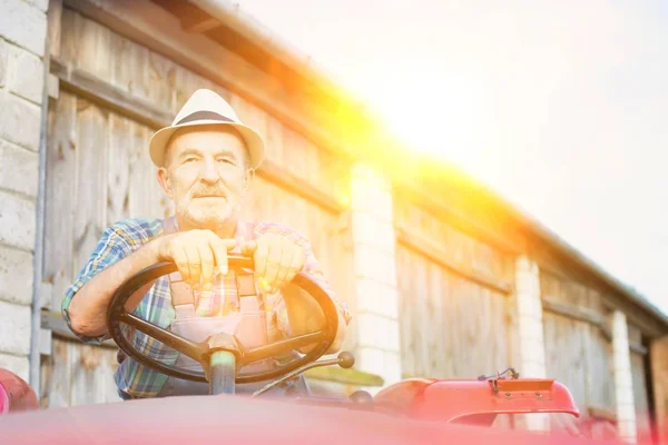 Portrait Smiling Senior Farmer Sitting Tractor Barn Farm — Stock Photo, Image