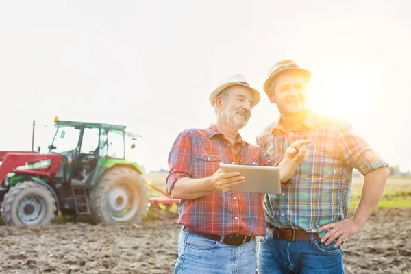 Farmáři Mluví Při Používání Digitálních Tabletu Farmě Slunečný Den — Stock fotografie