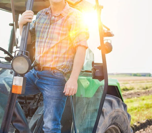 Çiftlikte güneşli bir günde hasat yapan adam.