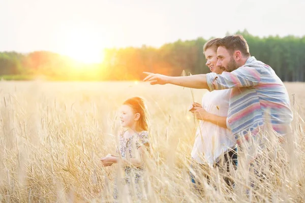 Father pointing on something on field