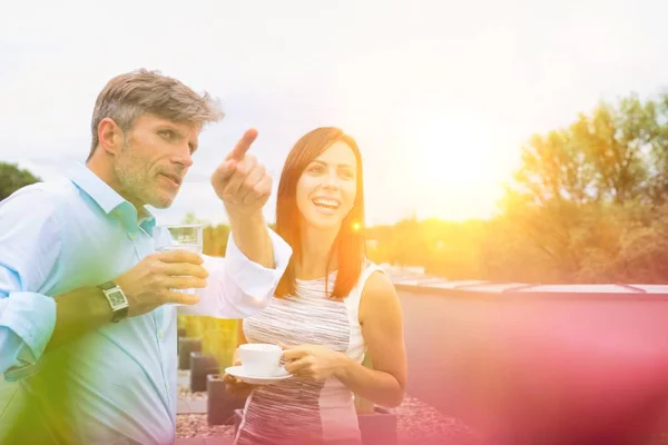 Business people working in office with strong lens flare in background