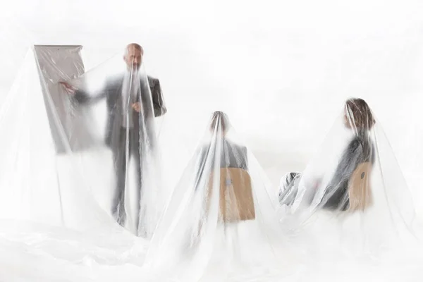 Business People Meeting While Being Covered Plastic - Stock-foto