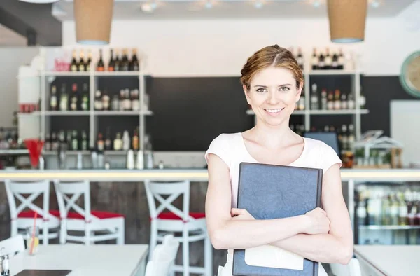 Portrait Smiling Young Waitress Holding Menu While Standing Restaurant — Stock Photo, Image