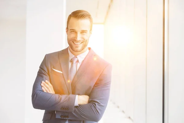 Portrait Smiling Handsome Young Businessman Standing Arms Crossed New Office — Stock Photo, Image