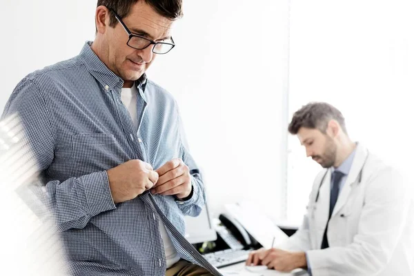 Mature Patient Buttoning Sleeves Check Doctor Clinic — Foto de Stock
