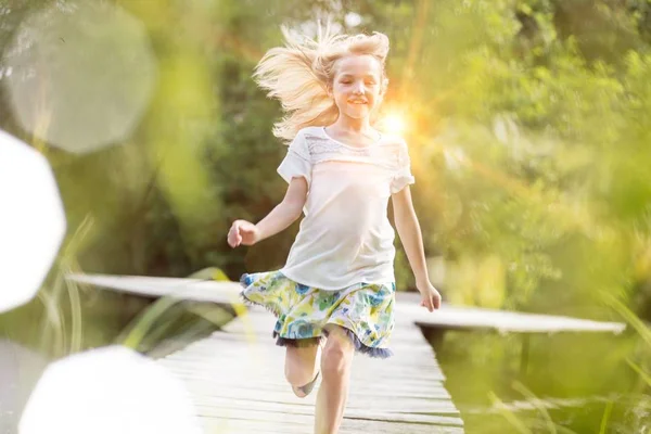 Portrait Little Girl Running Pier Lens Flare Background — Stock Photo, Image