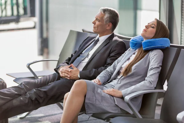 成熟した実業家と若い魅力的なビジネスマン空港で彼らのゲートで搭乗を待っている間寝ている女性 — ストック写真
