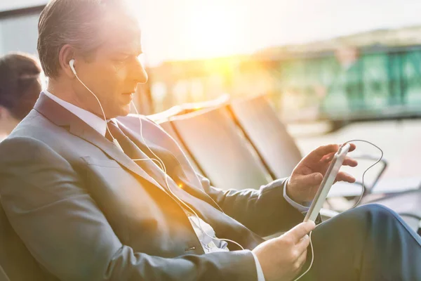 Portrait Mature Businessman Using Digital Tablet Earphones While Waiting Boarding — Stock Photo, Image