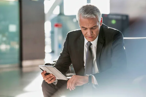 Mature Businessman Using Digital Tablet While Checking Time His Watch — Stock Photo, Image