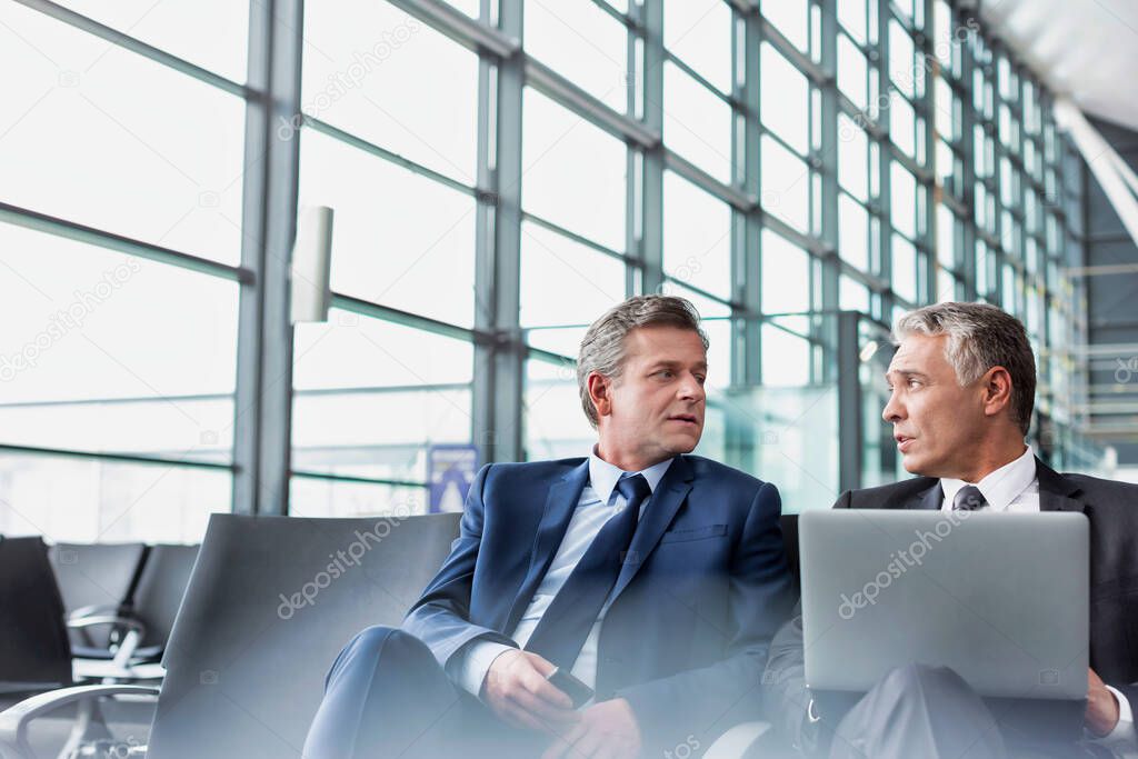 Mature businessman waiting for boarding in airport