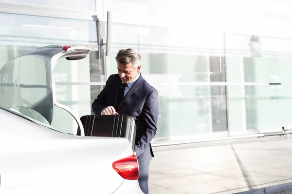 Attractive Mature Businessman Putting His Luggage Car Trunk — Stock Photo, Image