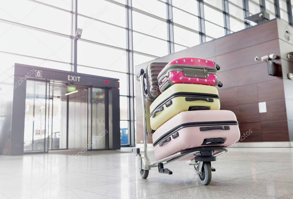 baggage on cart with lens flare in airport