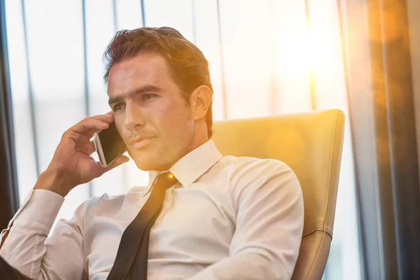 Mature Businessman Talking Smartphone Yellow Lens Flare — Stock Photo, Image