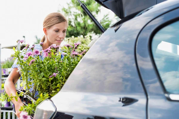 Portret Dojrzałej Kobiety Ogrodnik Wprowadzenie Kwiatów Bagażniku Samochodu Dostawy — Zdjęcie stockowe