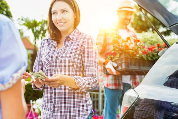 Female Customer Giving Cash Payment Shop Owner Mature Gardener Putting — Stock Photo, Image