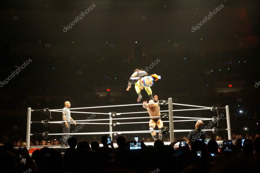HONOLULU - JUNE 29, 2016: WWE wrestlers Uso jumps over Karl Anderson in ring during tag match at WWE event at the Neal S. Blaisdell Center, Honolulu on June 29, 2016 Honolulu, Hawaii.
