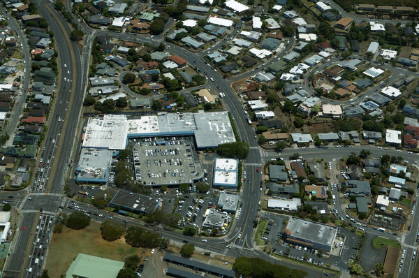 Aerial of Likelike Highway, Kam Shopping Center, surrounding Neighborhood with homes, Condos, and school on Oahu, Hawaii.