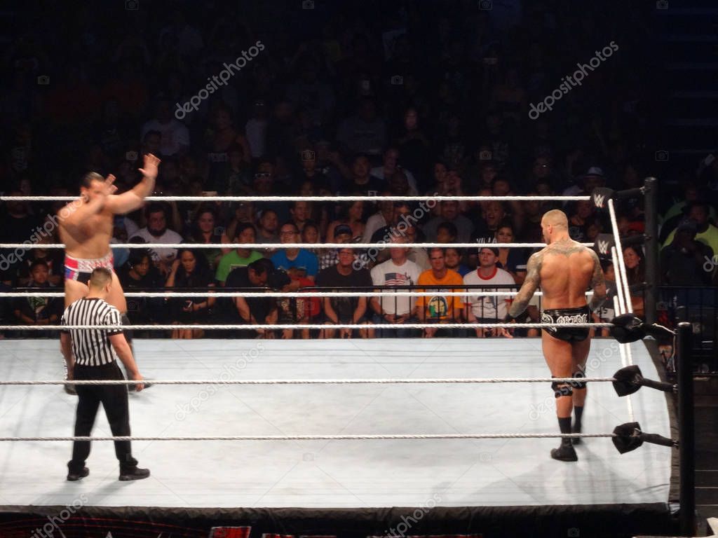 Honolulu - September 13, 2017: WWE Wrestler Rusev and wrestler Randy Orton stand ready to fight with ref looking on in WWE ring at WWE event at the Neal S. Blaisdell Center, Honolulu on September 13, 2017.