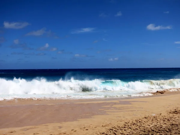 Waves crash on along Makapuu beach Stock Picture