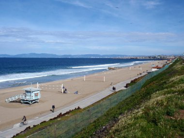 LA - March 7, 2010: Redondo Beach with birds in the sky and people exploring in LA. clipart