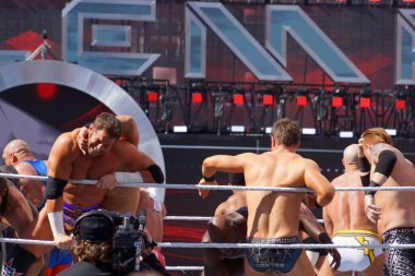 Santa Clara, California - March 29, 2015:  Andre the Giant battle royal 2015 with WWE Wrestler Zack Ryder is being throw over the ropes with Miz, Heath Slater and other wrestlers fighting in ring during at Wrestlemania 31 at the Levi's Stadium.  clipart