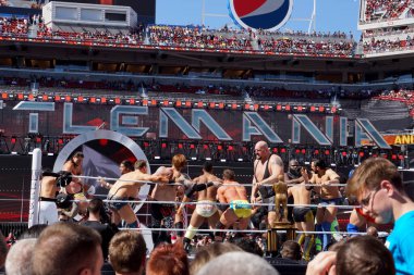 Santa Clara, California - March 29, 2015:  Andre the Giant battle royal 2015 with WWE Wrestlers Damien Sandow, Big Show, Miz, Heath Slater, Mark Henry, Zack Ryder and other wrestlers fighting in ring during  at Wrestlemania 31 at the Levi's Stadium.  clipart