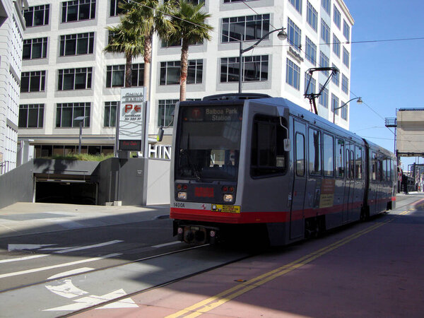 San Francisco - April 6, 2010: T Muni Light-rail train with ad on side on 4th street in Mission Bay.            