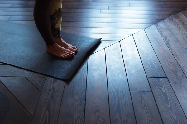 Flickan står på mattan, stretching tår — Stockfoto