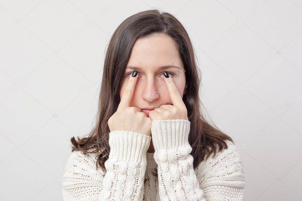 girl  holding her fingers in front of eyes. 