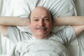 man lying in bed 
